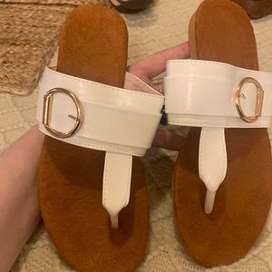 Cute white thong sandals with gold buckles accent!